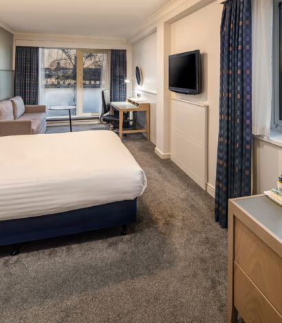 Large double bedroom's decorated in white and chocolate with duel aspect windows overlooking the Marina. room also includes Bedside tables with side lamps, 2 seater sofa, 2 dressing tables, flat screen TV.