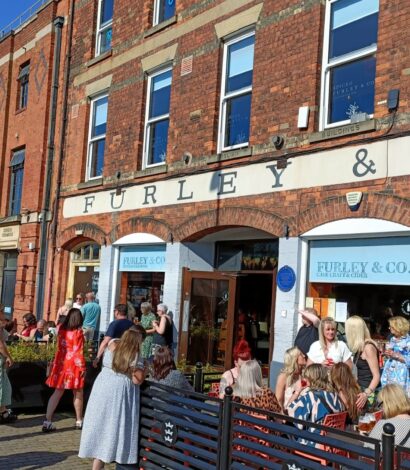Exterior view of Furley & Co, a modern bar and restaurant in Hull, UK. The building features large windows, outdoor seating, and signage, creating a welcoming atmosphere in an urban setting