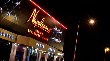 Exterior of Napoleons Casino in Hull, featuring a modern entrance with illuminated signage. The venue offers gaming, dining, and entertainment in a stylish setting.