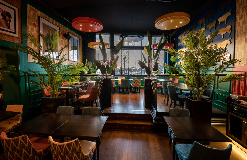 Interior of The Brazilian Churrascaria & Bar, featuring a warm and vibrant dining space with stylish décor. The restaurant’s inviting atmosphere is enhanced by comfortable seating and wood furnishings, ambient lighting, and a focus on authentic Brazilian cuisine