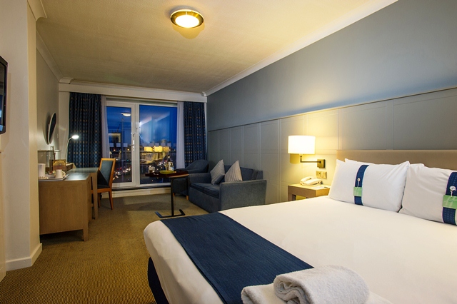 Hotel bedroom showing Bed, Sofa bed and Balcony doors