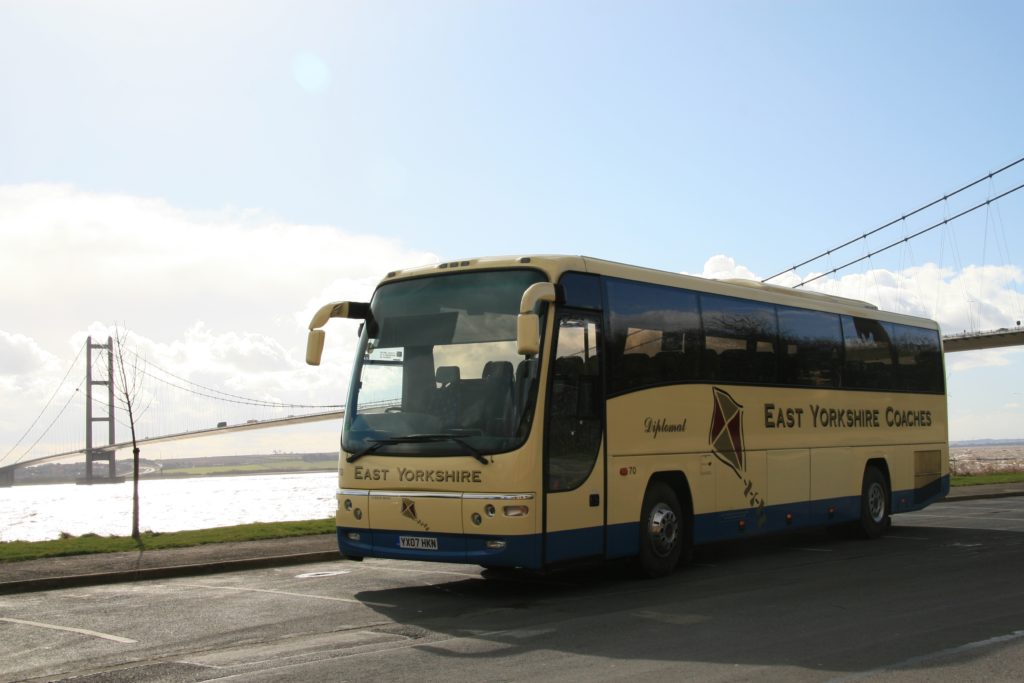 East Yorkshire Coach with the Humber Bridge a single span suspension bridge and the Humber Estuary in the background