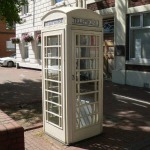 A white telephone box in Hull, a distinctive feature of the city’s independent telephone network. The iconic kiosk stands out against its surroundings, representing Hull’s unique telecommunications history