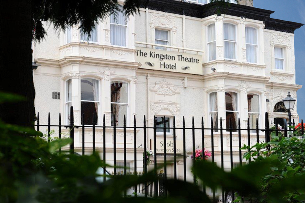 Hotel frontage. White Georgian building with iron railings in the foreground