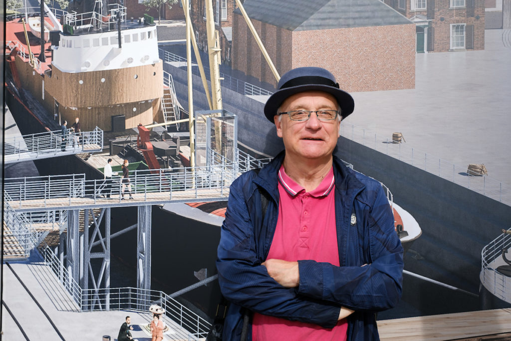 Local tour guide Paul Schofield In front of a digital representation of the Arctic Corsair a side winder trawler from 1970's.
