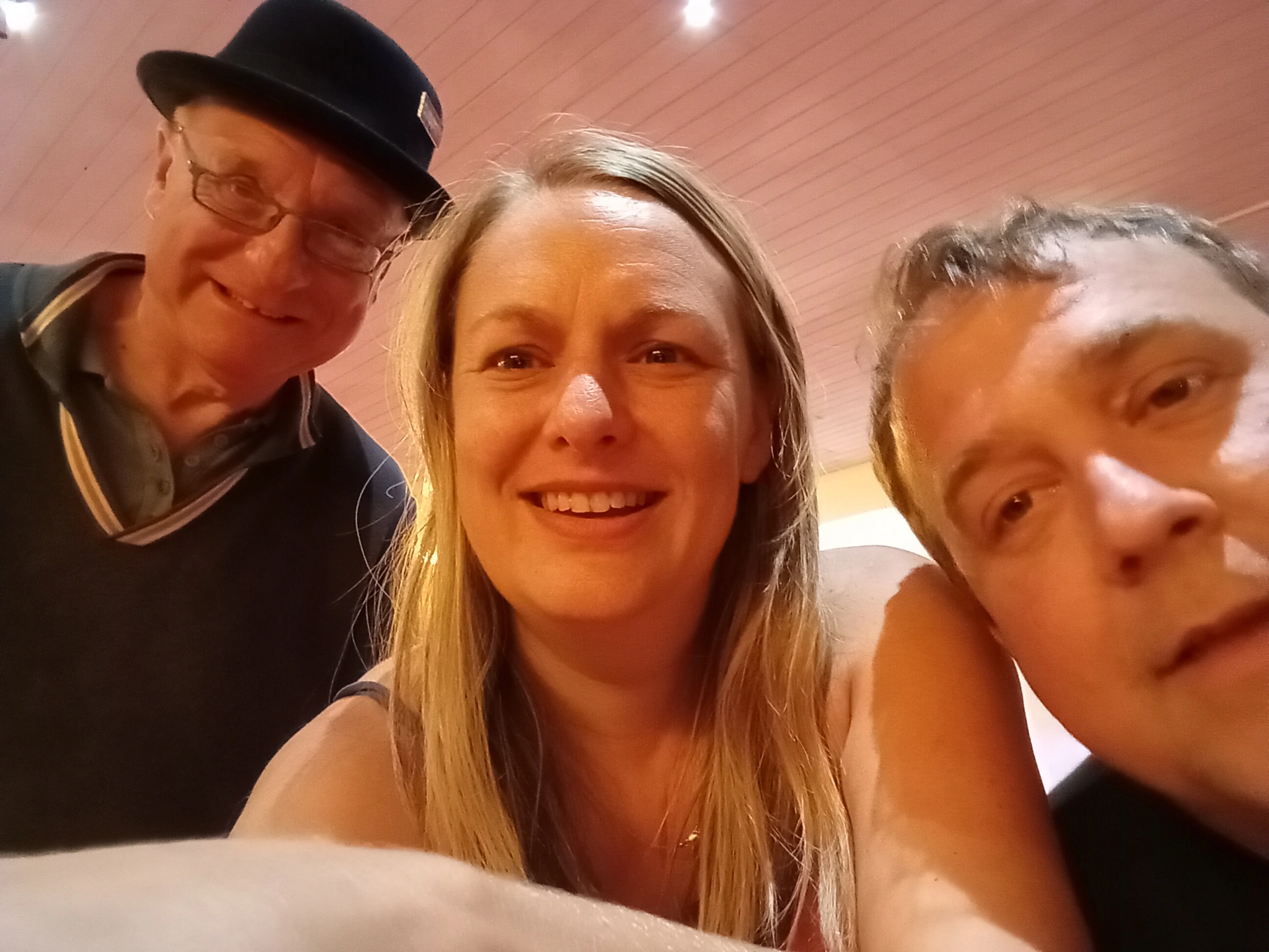 1 Female and 3 Males smiling into the Camera