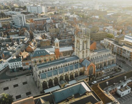 sunrise drone shot of Hull Minster and Trinity Square with the turret of Trinity Market in the background